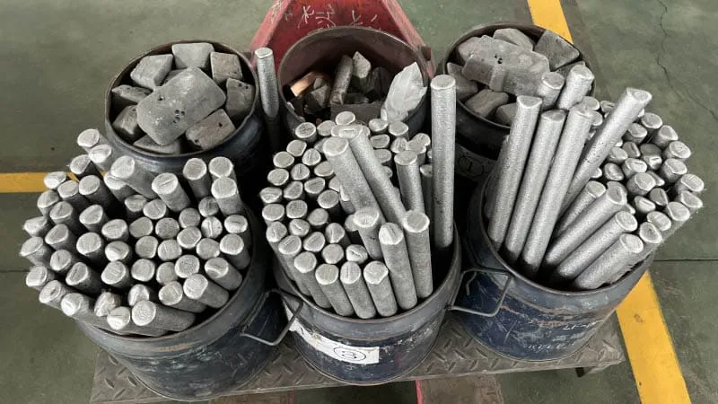 Raw materials for neodymium magnets, including rare earth elements and alloys, ready for processing and manufacturing.